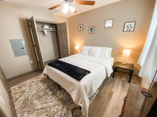 a bedroom with a large white bed and a fan at Charming 1BR Getaway - Private, Pet Friendly, TV in Texas City