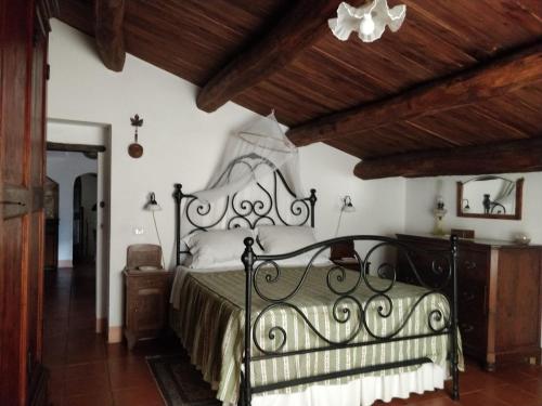 a bedroom with a bed and a wooden ceiling at CASALE SPOLETO in Spoleto