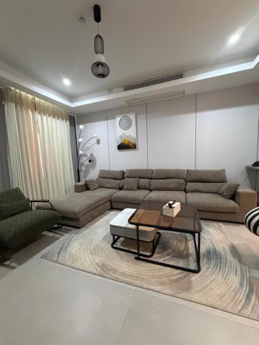 a living room with a couch and a coffee table at Serene Keys Homes in Otinshi