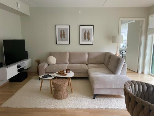 a living room with a couch and a table at Modern apartment with a private garage in Lørenskog Oslo in Lorenskog