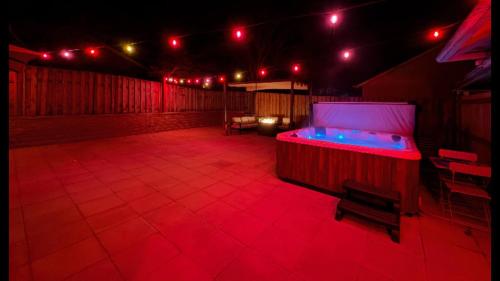 a hot tub in the middle of a patio at night at Cozy Seaside Bungalow, Brand New Hot Tub, Fast WiFi & W&D - Walk to the Beach in Seaside