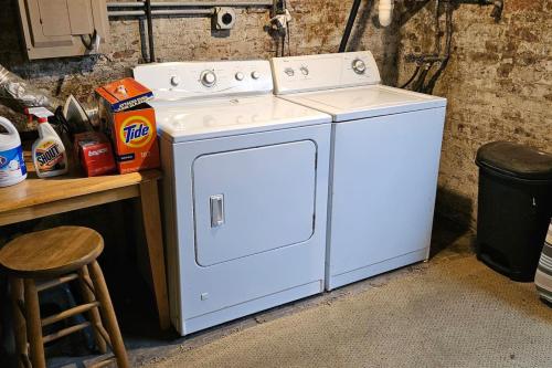 a white washer and dryer sitting next to a counter at Robin's Egg, Private Downtown, Pet-Friendly Gem in Columbus
