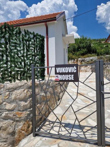 a sign on a gate in front of a house at Vuković house - Lake View & Nature in Kuside