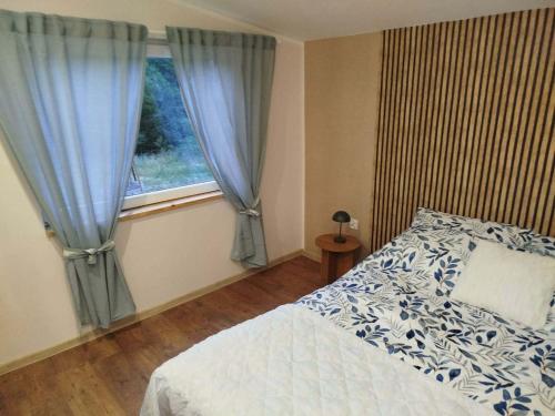 a bedroom with a bed and a window at Apartamenty nad Brdą in Zapędowo