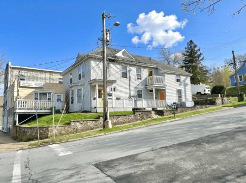 a white house on the side of a street at Summer Sale 1BR Big Kitchen by River and Trails in Bridgewater