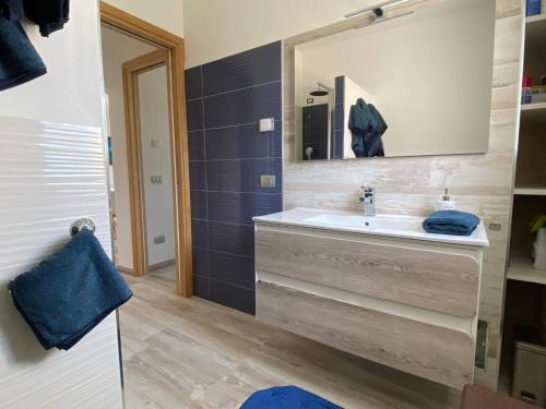 a bathroom with a sink and a mirror at RH1 and RH2 - PuntoCasaBudoni in Budoni