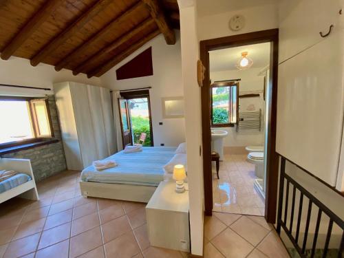 a bedroom with a bed and a bathroom at Castello Cottage in Argegno