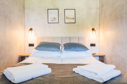 a bedroom with a bed with two pillows on it at Domki u Basi - 250m do Plaży - Idealne dla Rodzin in Karwia