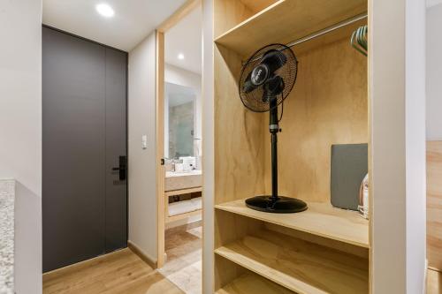 a room with a fan sitting on a shelf at El Pocito by Homirent in El Jacal