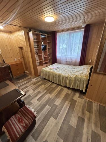 a small bedroom with a bed and a window at Смарт-Квартира in Yaremche