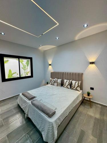 a bedroom with a large bed in a room at Pool House et Rooftop Hammamet in Dar Hamad Jedidi