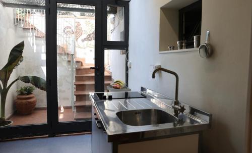 a sink in a kitchen with a view of a staircase at B&B Camilla in Rimini