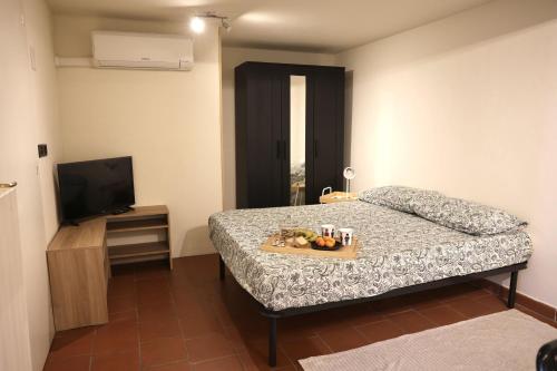 a bedroom with a bed with a tray of fruit on it at B&B Camilla in Rimini