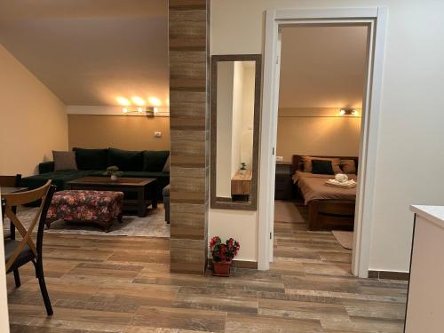 a living room with a couch and a table at Apartmani Kovačević MKM Banja Vrujci in Gunjica