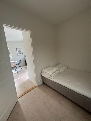 a bedroom with a bed and an open door at Höllviksstugan in Höllviken