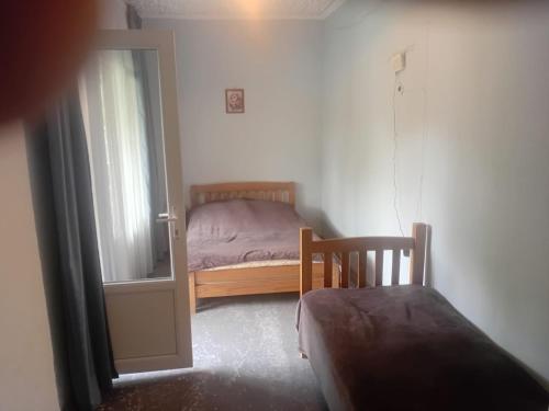 a small bedroom with a bed and a window at borjomi downtown in Borjomi