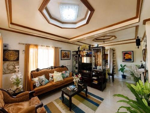 a living room with a couch and a table at Romar's Place Roxas Orientl, Mindoro in Roxas