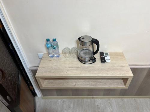 a coffee maker and glasses on a wooden table at El Emir in Samarkand