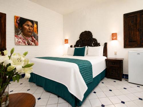 a hotel room with a large bed in a room at Hotel Casa Dona Susana by Los Arcos in Puerto Vallarta