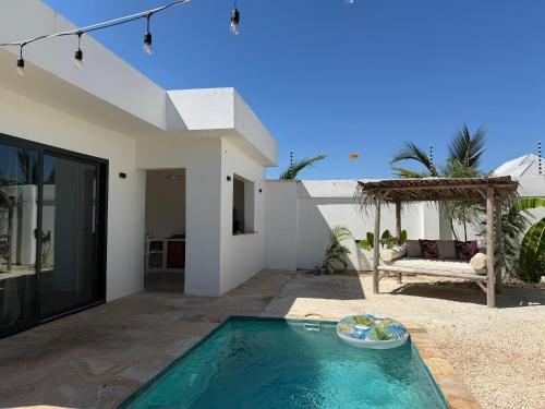 a swimming pool in the backyard of a house at U PARADISU VILLAS - Private Pool in Jambiani