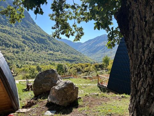 a view of a mountain range with two rocks at Andi's Home in Bogë