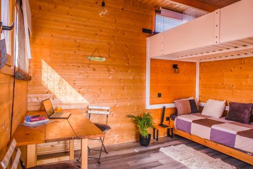 a bedroom with a bed and a desk in a room at Aloha Studio in La Oliva