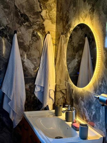 a bathroom with a sink and a mirror at Remizovka Mount in Almaty