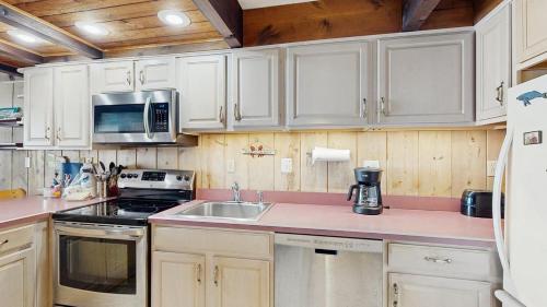 a kitchen with white cabinets and a sink at White Sands Village 27 in Ocean City