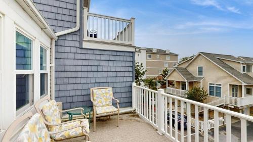 a balcony with two chairs on a house at White Sands Village 27 in Ocean City