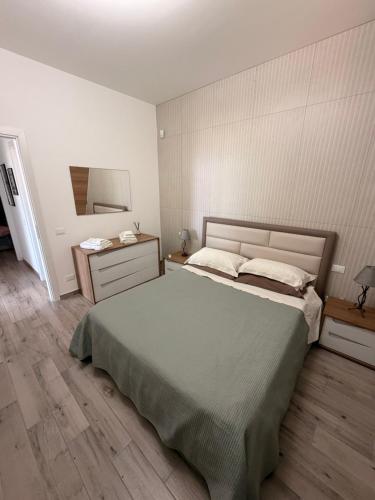 a bedroom with a bed and a dresser and a mirror at Villa Marina Luxury in Balestrate