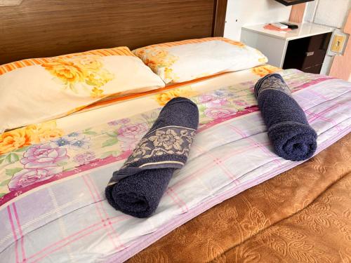 two pairs of socks are laying on a bed at Comunidade Anuncia-Me in Guaratinguetá