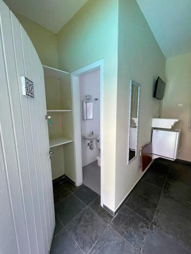 a bathroom with a toilet and a sink at Pousada Morada do Tombo in Guarujá