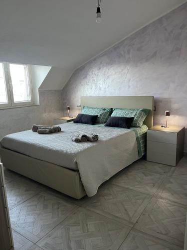 a bedroom with a large bed with two night stands at Domus Enricucciu in Lanusei