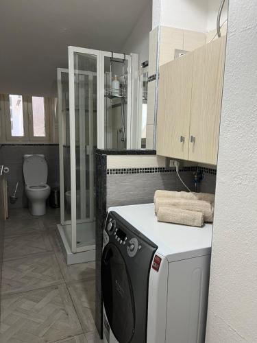 a bathroom with a washer and dryer in it at Domus Enricucciu in Lanusei