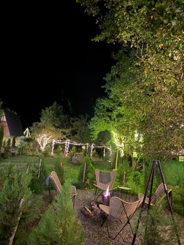 a backyard at night with chairs and a fire pit at Landhaus Borjomi in Borjomi