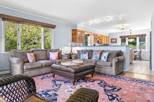 a living room with a couch and a table at Charming home with stunning bay views, sunroom, gazebo, deck, & grill in Trenton