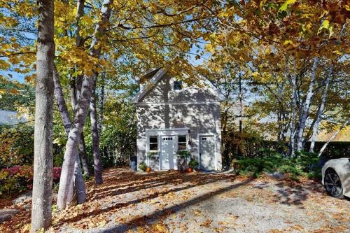 a small house in the middle of some trees at Charming coastal cottage with firepit and easy beach access in Rockport
