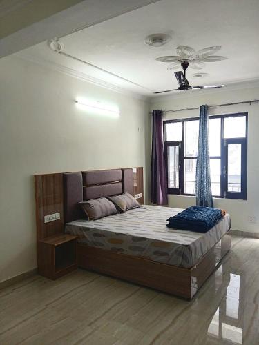 a bedroom with a large bed in a room at RCA Homestay in Dharmsāla