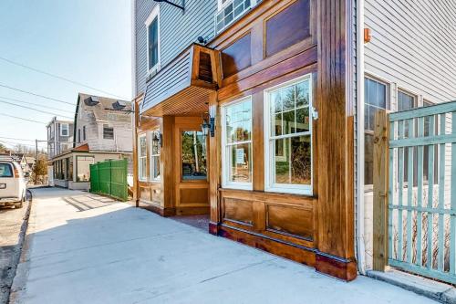 a house with a wooden door on a street at Comfortable Suite in Downtown Northeast Harbor w/ WiFi & AC - Walk to the Water in Northeast Harbor