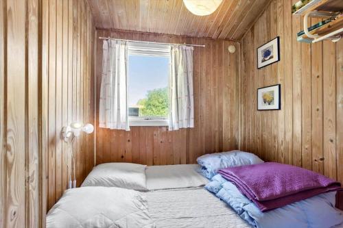 a bed in a room with a window at FY125-Middelfart-Capellavej-16 in Middelfart