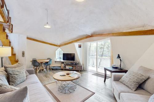 a living room with a couch and a table at Geodesic Dome w/ Riverfront Deck, Lovely Views, & High-Speed WiFi - Dogs Welcome in Boothbay