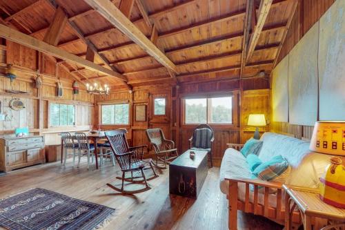 a living room with a couch and a table at Waterfront cabin with ocean view & private dock in East Boothbay