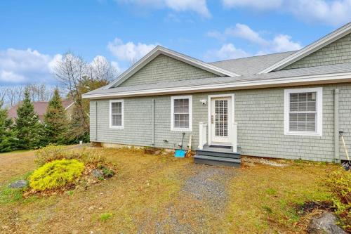 a gray house with a yard in front of it at New Condo w/Water-View Deck in Edgecomb in Edgecomb