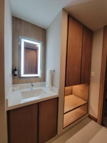 a bathroom with a sink and a mirror at Hotel Alameda in Tegucigalpa