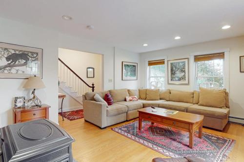 a living room with a couch and a table at Gorgeous, walkable home with water view, deck & washer/dryer - snowbird-friendly in Camden