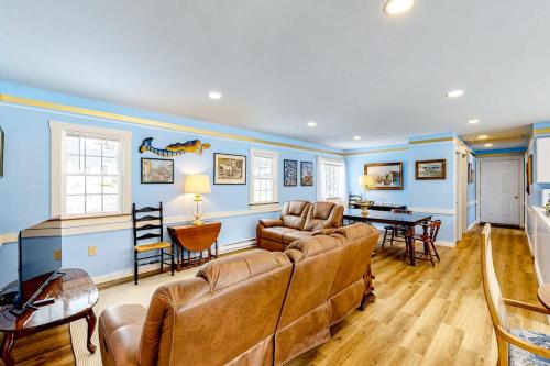 a living room with a couch and a table at Colorful duplex home with a large yard, deck, WiFi, & ideal Midcoast location in Boothbay