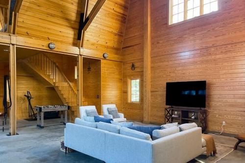 a living room with couches and a flat screen tv at Spectacular oceanfront retreat with amazing views, sunroom & washer/dryer in Georgetown