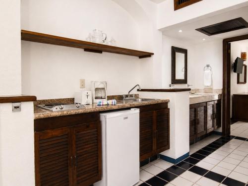 a kitchen with a sink and a counter top at Los Arcos Suites in Puerto Vallarta