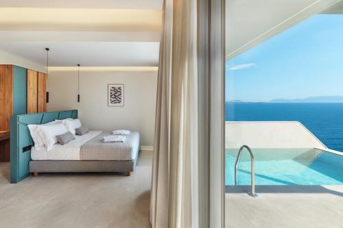 a bedroom with a bed and a view of the ocean at Merivian Seaside Suites in Kanali
