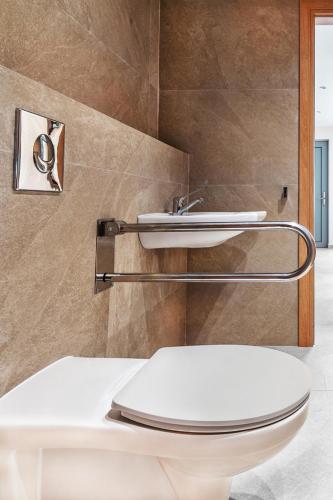 a bathroom with a toilet and a sink at Merivian Seaside Suites in Kanali